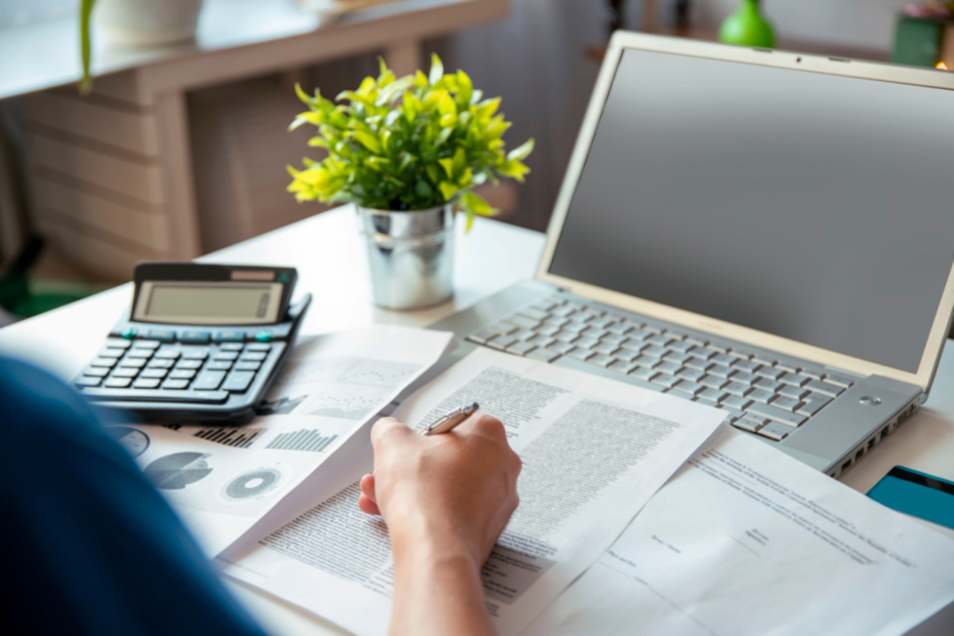 Man hands working at desk with paper documents